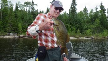 Man holding Smallmouth Bass caught at Big Canon Lake Lodge